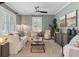 Charming living room with neutral walls, large windows with plantation shutters, and stylish furnishings at 1 Marlow Dr, Charleston, SC 29403