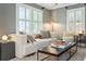 Cozy living room with a plush white couch, large windows, and stylish decor at 1 Marlow Dr, Charleston, SC 29403
