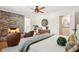 Cozy main bedroom with brick fireplace, hardwood floors, and stylish furnishings at 1 Marlow Dr, Charleston, SC 29403