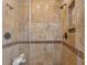 Close-up of tiled shower with glass door featuring dual shower heads and recessed shelving at 1 Marlow Dr, Charleston, SC 29403
