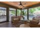 Relaxing sunroom with wooden ceiling, ceiling fan, cushioned wicker seating, and views of the outdoor landscape at 1 Marlow Dr, Charleston, SC 29403