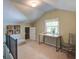 Finished attic space with natural light, built-in shelving, and versatile layout at 1006 Ibis Ct, Mount Pleasant, SC 29464