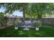 Inviting backyard patio featuring comfortable seating, lush green lawn, and shaded trees at 1006 Ibis Ct, Mount Pleasant, SC 29464