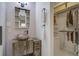 Bathroom features a unique stone sink and vanity, complemented by modern fixtures and a well-organized walk-in closet at 1006 Ibis Ct, Mount Pleasant, SC 29464