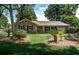 Charming brick home with a well-manicured lawn, mature trees, and inviting front porch at 1006 Ibis Ct, Mount Pleasant, SC 29464