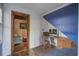 Home office space with a wooden desk, blue accent wall, and view into another room at 1006 Ibis Ct, Mount Pleasant, SC 29464