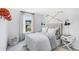 Light filled bedroom with decorative headboard and window with outdoor view at 1015 Swamp Rose Run, Summerville, SC 29485