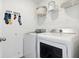 Functional laundry room equipped with modern washer and dryer units and storage solutions at 1015 Swamp Rose Run, Summerville, SC 29485