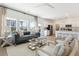 Open-concept living room with large windows and a view of the kitchen at 1015 Swamp Rose Run, Summerville, SC 29485