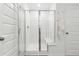 Shower with sliding glass doors, built-in seat, and white tile surround at 1015 Swamp Rose Run, Summerville, SC 29485