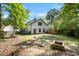 Spacious backyard with a rock border, fire pit, and green grass surrounded by a wooden fence at 1016 Cider Ct, Summerville, SC 29483