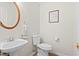 Powder room features a pedestal sink, decorative mirror, and modern toilet at 1016 Cider Ct, Summerville, SC 29483