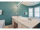 Well-lit bathroom with double sinks and a large mirror at 1016 Cider Ct, Summerville, SC 29483