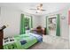 Cozy bedroom with neutral carpet, ceiling fan, and green curtains that let in plenty of natural light at 1016 Cider Ct, Summerville, SC 29483