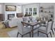 Elegant dining area with a table for six, a fireplace, and large windows that offer ample natural light at 1017 Swamp Rose Run, Summerville, SC 29485