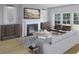 Cozy living room with a fireplace, hardwood floors, and stylish decor at 1017 Swamp Rose Run, Summerville, SC 29485