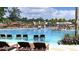 Inviting pool area with in-water loungers, palm trees, and umbrellas for a relaxing experience at 1017 Swamp Rose Run, Summerville, SC 29485