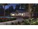 A tranquil poolside scene at dusk featuring cozy seating, a bar, and ambient lighting for a relaxing evening at 1017 Swamp Rose Run, Summerville, SC 29485
