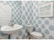 Charming powder room showcasing stylish leaf-patterned wallpaper and a modern vanity at 1021 Swamp Rose Run, Summerville, SC 29485