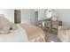 Bright bedroom featuring neutral decor, a mirror accent cabinet, and soft furnishings at 1021 Swamp Rose Run, Summerville, SC 29485