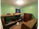 A bedroom with bright green walls, with a wooden bunk bed and dresser at 1022 Miles Jamison Rd, Summerville, SC 29485