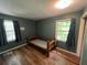 Bedroom with hardwood flooring, two windows, and dark teal walls at 1022 Miles Jamison Rd, Summerville, SC 29485