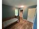 A bedroom with hardwood floors, blue-green walls and a closet at 1022 Miles Jamison Rd, Summerville, SC 29485