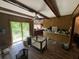 View of the living area featuring wood-look floors, ceiling beams, and sliding glass doors at 1022 Miles Jamison Rd, Summerville, SC 29485