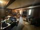 A living room with wood walls and ceiling beams, cluttered with belongings at 1022 Miles Jamison Rd, Summerville, SC 29485