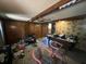 A cluttered living room with wood paneling and a ceiling fan at 1022 Miles Jamison Rd, Summerville, SC 29485