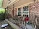 Close-up of the home's porch featuring brick columns, iron railings, and seating area at 1022 Miles Jamison Rd, Summerville, SC 29485