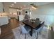 A cozy dining area featuring modern chandelier and opening to the large kitchen with stainless appliances at 104 Pine Waters Ln, Summerville, SC 29483