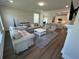 A well lit living room with contemporary furnishings and stylish decor open to the kitchen and dining at 104 Pine Waters Ln, Summerville, SC 29483