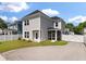 The home features a spacious backyard with lush green grass, privacy fence, and stylish siding at 104 Pine Waters Ln, Summerville, SC 29483