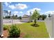 Backyard view showing a detached garage, privacy fence, and young landscaping at 104 Pine Waters Ln, Summerville, SC 29483