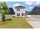 The home features a spacious backyard with lush green grass, and privacy fence at 104 Pine Waters Ln, Summerville, SC 29483