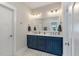 Modern bathroom features double sinks, a large mirror, and blue cabinets at 104 Pine Waters Ln, Summerville, SC 29483