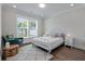 Serene bedroom with a plush rug, a comfortable bed, and a large window offering peaceful views at 104 Pine Waters Ln, Summerville, SC 29483