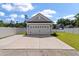 Spacious two-car garage with a wide driveway, complemented by a green lawn and white fence at 104 Pine Waters Ln, Summerville, SC 29483