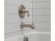 Close-up of a stylish bathtub faucet with white subway tile surround at 104 Pine Waters Ln, Summerville, SC 29483