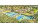 Aerial view of community tennis courts surrounded by lush greenery, showcasing recreational amenities and beautiful landscaping at 105 Irish Oak Dr, Goose Creek, SC 29445