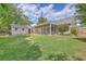 Spacious backyard featuring a screened porch, shed, and lush green lawn, perfect for outdoor living and entertaining at 105 Irish Oak Dr, Goose Creek, SC 29445