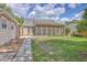 Backyard featuring a screened-in porch, a stone walkway, and a grassy lawn at 105 Irish Oak Dr, Goose Creek, SC 29445