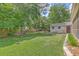 Lush backyard featuring a shed, green grass, and a stone border, ideal for relaxing and enjoying nature at 105 Irish Oak Dr, Goose Creek, SC 29445