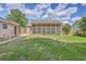 Wide backyard with grass and a screened-in porch adjacent to the house at 105 Irish Oak Dr, Goose Creek, SC 29445