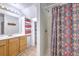 Bathroom features a vanity, shower with colorful curtain, and built-in shelves for storage at 105 Irish Oak Dr, Goose Creek, SC 29445