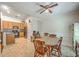 Bright dining room with wooden table set, ceiling fan, adjacent to the kitchen with stainless steel appliances at 105 Irish Oak Dr, Goose Creek, SC 29445