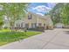 Charming two-story home with a well-maintained lawn, mature trees, and a long driveway, showcasing curb appeal at 105 Irish Oak Dr, Goose Creek, SC 29445