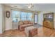 Cozy living room with hardwood floors, a comfortable sofa, and natural light streaming through the window at 105 Irish Oak Dr, Goose Creek, SC 29445