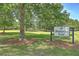 Community park entrance with a sign, framed by mature trees and a well-maintained lawn, inviting outdoor enjoyment at 105 Irish Oak Dr, Goose Creek, SC 29445